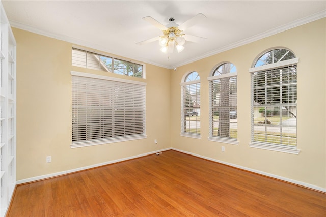 spare room with crown molding, wood-type flooring, and ceiling fan