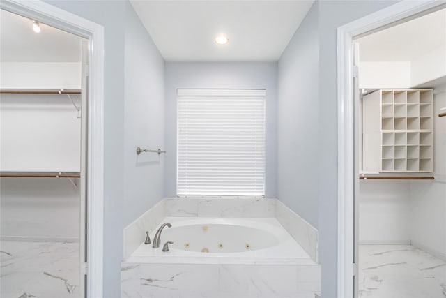 bathroom featuring tiled bath