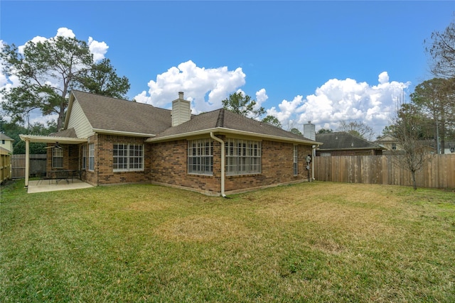 back of house featuring a yard and a patio