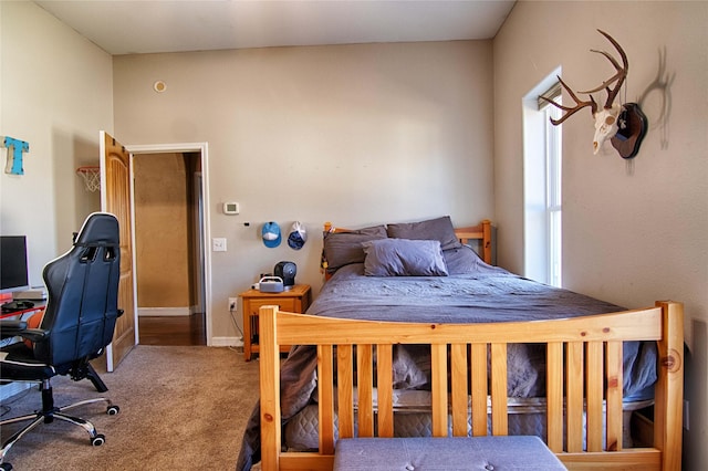 bedroom featuring baseboards and carpet