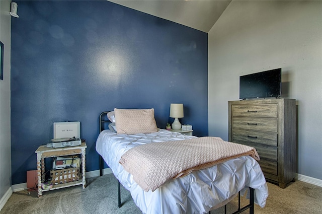bedroom with carpet flooring, baseboards, and lofted ceiling