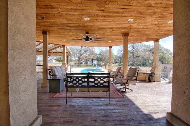 wooden terrace featuring outdoor dining space and ceiling fan
