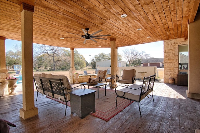 deck featuring a patio, a ceiling fan, and an outdoor hangout area