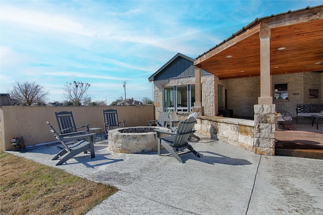 view of patio / terrace with a fire pit and fence