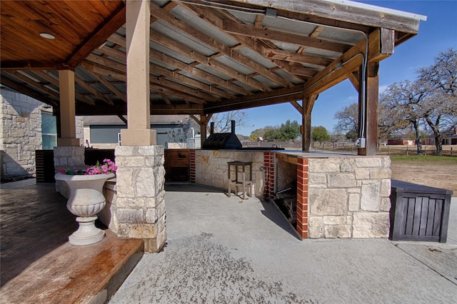 view of patio / terrace featuring outdoor dry bar and area for grilling