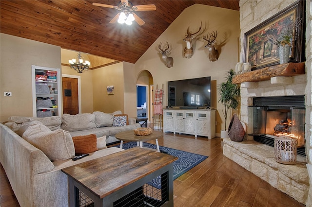 living room featuring dark wood-type flooring, ceiling fan with notable chandelier, high vaulted ceiling, a stone fireplace, and wooden ceiling