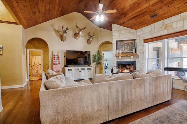living room featuring arched walkways, wooden ceiling, vaulted ceiling, and ceiling fan