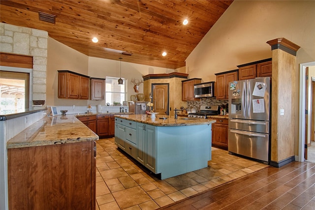 kitchen featuring visible vents, appliances with stainless steel finishes, wood ceiling, a center island with sink, and high vaulted ceiling