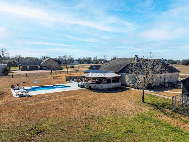 view of swimming pool with a patio, a fenced backyard, a pool with connected hot tub, a gazebo, and a lawn