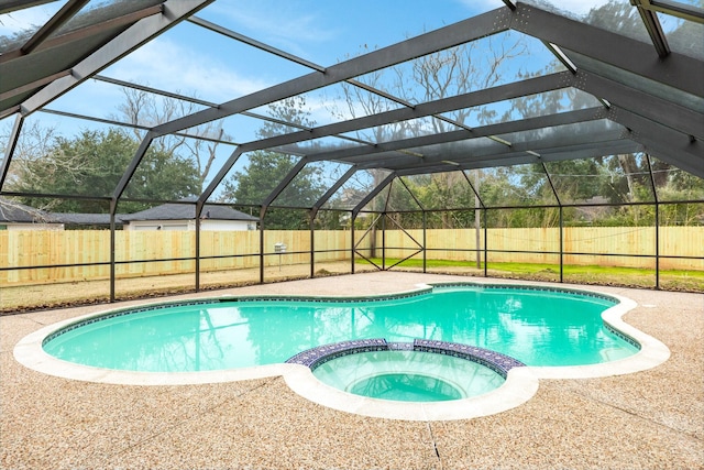 view of pool featuring a patio, a lanai, and an in ground hot tub