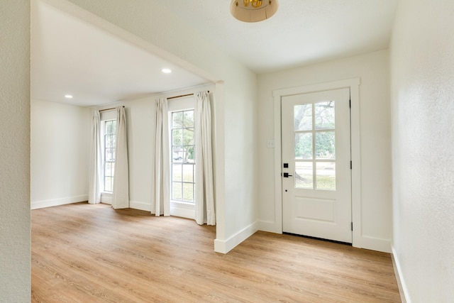 doorway to outside with light wood-type flooring