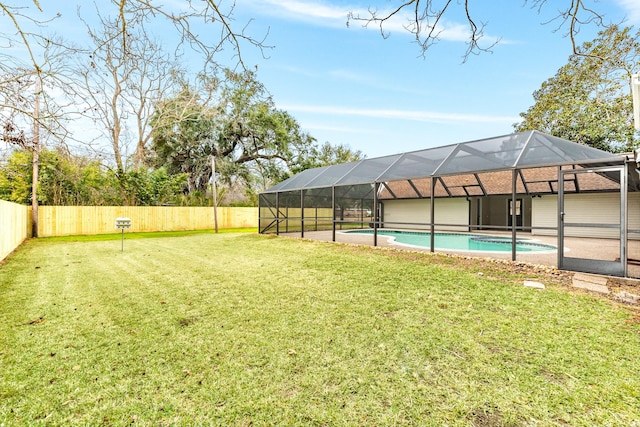 view of yard with a fenced in pool and glass enclosure