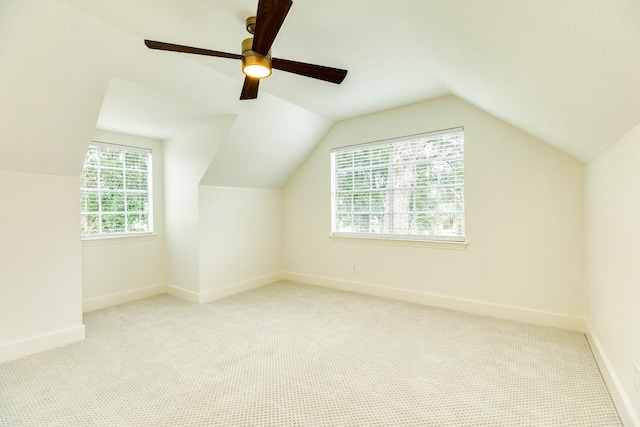 bonus room featuring light colored carpet and vaulted ceiling