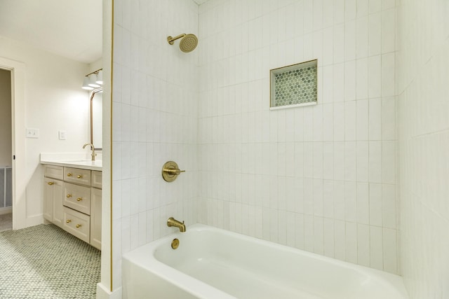 bathroom featuring tile patterned floors, vanity, and tiled shower / bath combo