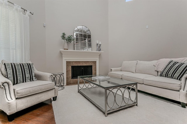 living room featuring a tiled fireplace