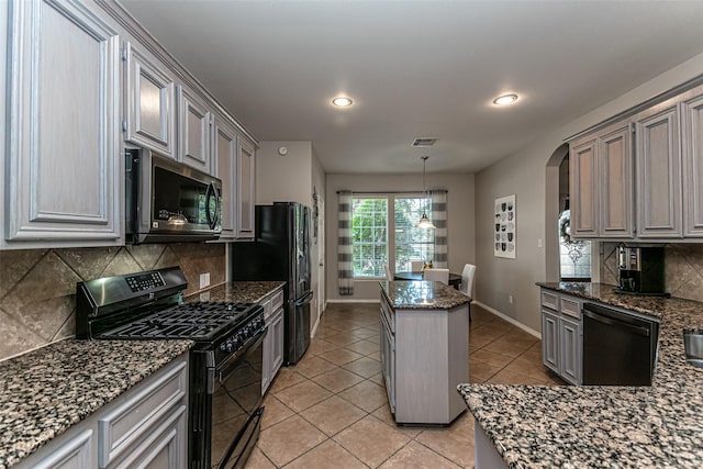 kitchen with black appliances, light tile patterned floors, pendant lighting, dark stone counters, and backsplash