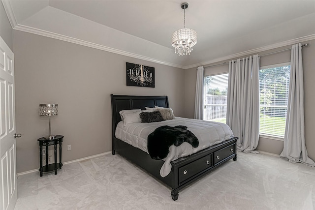 carpeted bedroom with an inviting chandelier and a tray ceiling