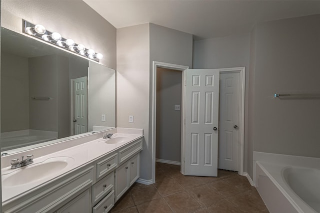 bathroom with vanity, tile patterned flooring, and a washtub