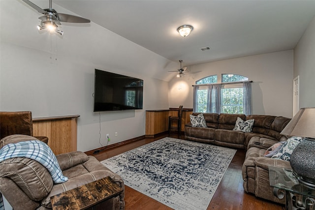 living room featuring vaulted ceiling, dark hardwood / wood-style floors, and ceiling fan