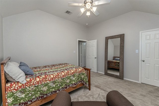 bedroom with ceiling fan, vaulted ceiling, and light carpet