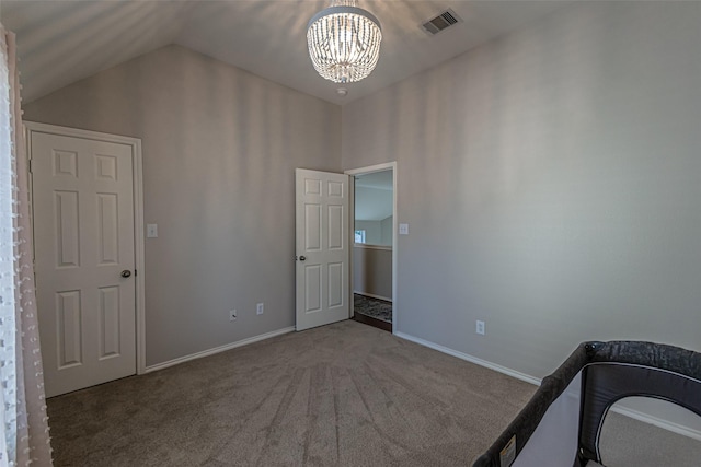 unfurnished bedroom featuring lofted ceiling, carpet floors, and a notable chandelier