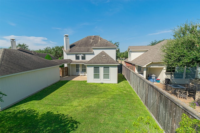 back of property with a patio and a lawn