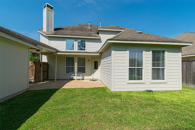 back of property featuring a yard and a patio area