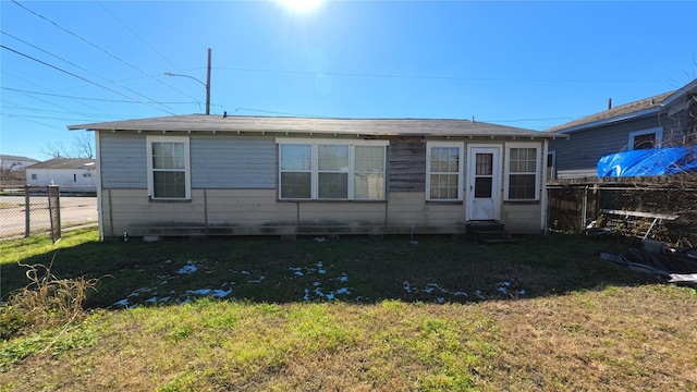 back of house with a lawn