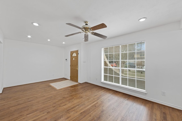 spare room featuring hardwood / wood-style flooring and ceiling fan