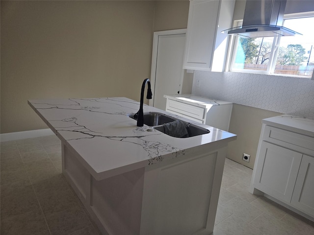 kitchen with sink, white cabinetry, a kitchen island with sink, island exhaust hood, and light tile patterned flooring