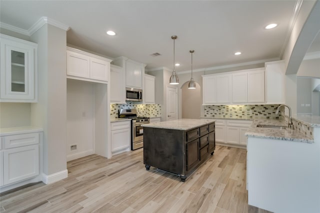 kitchen featuring white cabinetry, sink, and appliances with stainless steel finishes