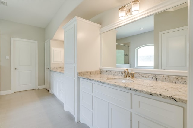 bathroom with vanity and a shower