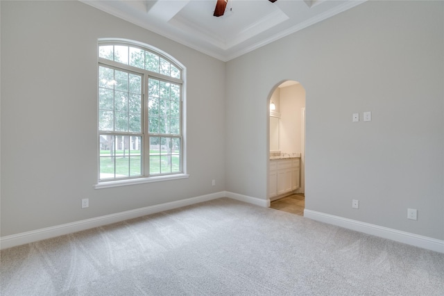 empty room with beamed ceiling, ornamental molding, coffered ceiling, and light colored carpet