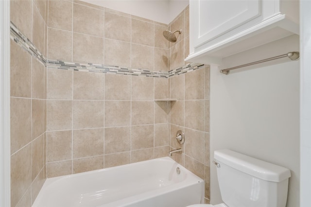 bathroom with tiled shower / bath combo and toilet