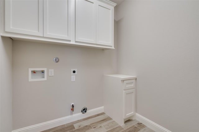 washroom featuring washer hookup, cabinets, hookup for a gas dryer, and hookup for an electric dryer