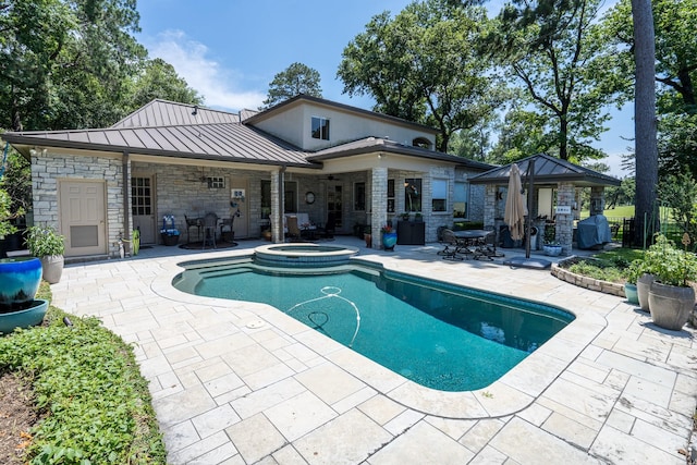 view of swimming pool with an in ground hot tub, a gazebo, and a patio area