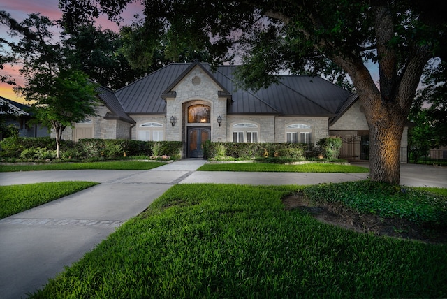 french country home with a lawn