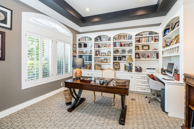 carpeted home office featuring built in shelves