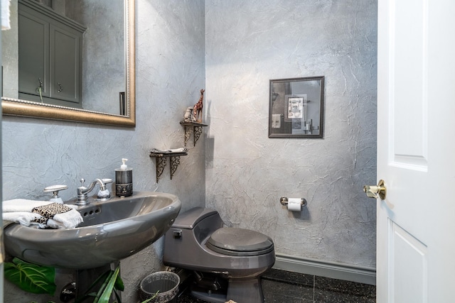 bathroom featuring toilet and tile patterned flooring