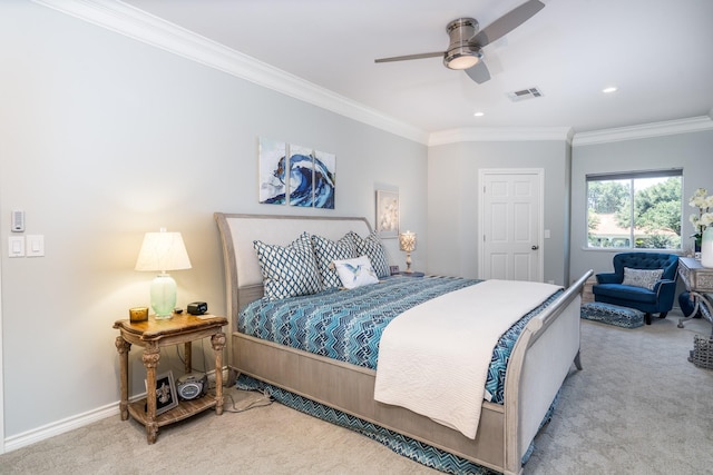 carpeted bedroom with ceiling fan and ornamental molding