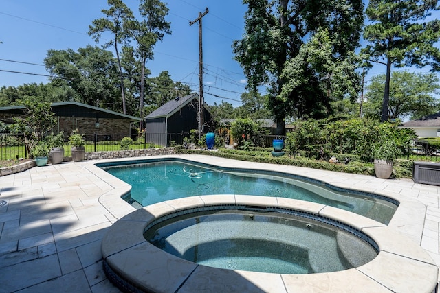 view of pool with an in ground hot tub and a patio area