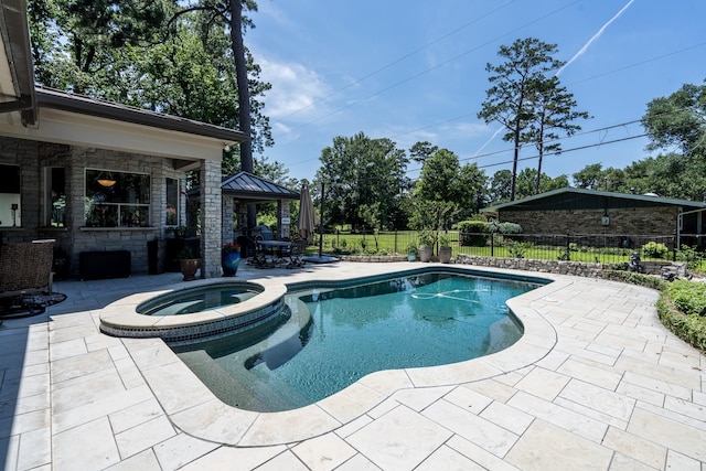 view of pool featuring an in ground hot tub, a gazebo, and a patio area