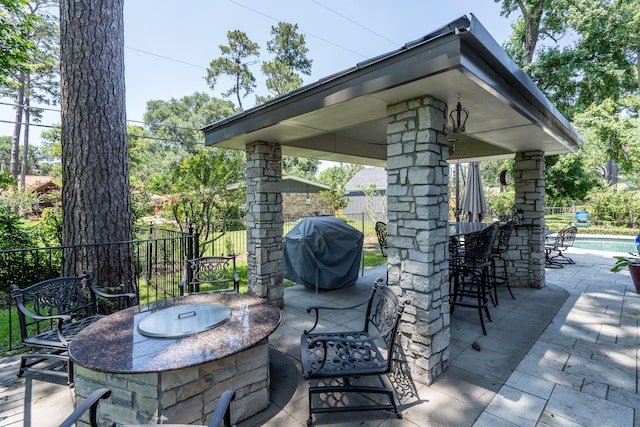 view of patio / terrace featuring grilling area and an outdoor bar