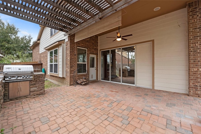 view of patio with area for grilling, a pergola, and exterior kitchen