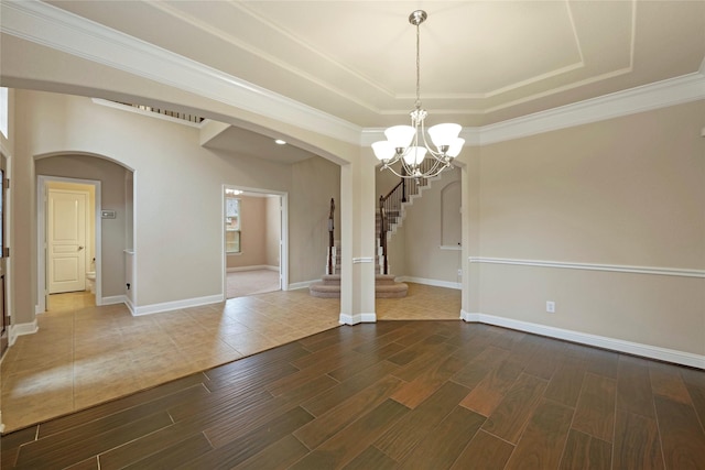 interior space featuring ornamental molding, a chandelier, and a tray ceiling