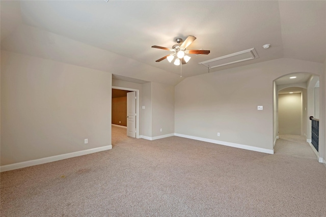 carpeted spare room featuring ceiling fan and lofted ceiling