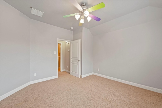 carpeted empty room featuring ceiling fan and lofted ceiling