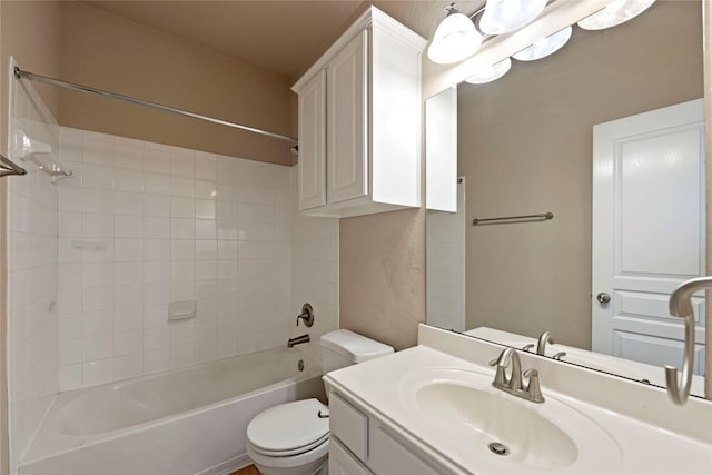 full bathroom with vanity, toilet, and tiled shower / bath combo