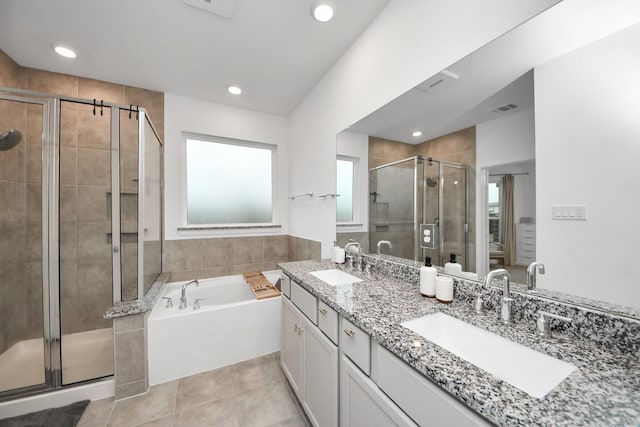 bathroom featuring vanity, independent shower and bath, and tile patterned flooring