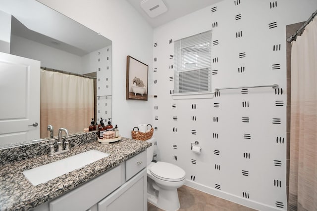 bathroom with tile patterned flooring, vanity, toilet, and walk in shower